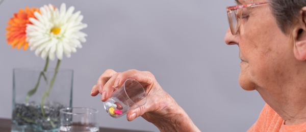 Elderly woman taking pills