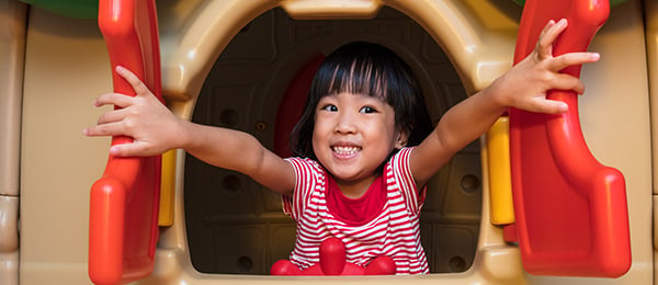 Young girl in a playhouse window