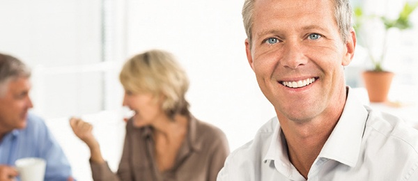 Man smiling at a dinner party