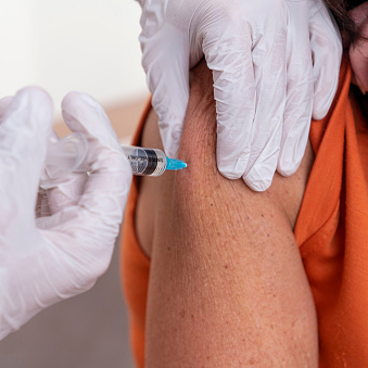 Person getting a vaccination in their arm 