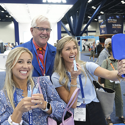 Smiling SmileCon attendees in Dental Central