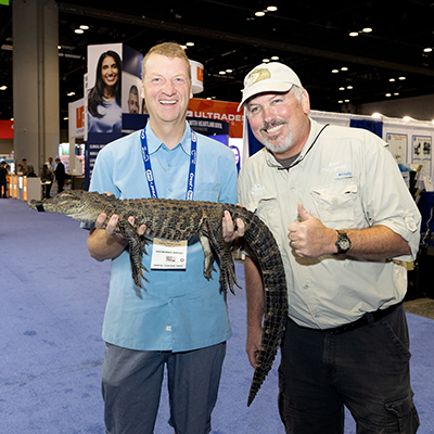 SmileCon attendees posing with a gator