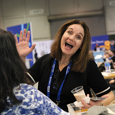 Happy SmileCon attendee waving while participating in activities