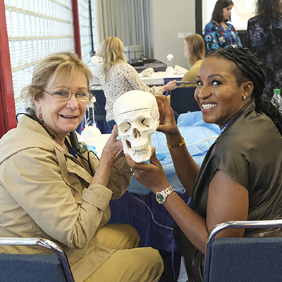 SmileCon participants holding medical skull during activity